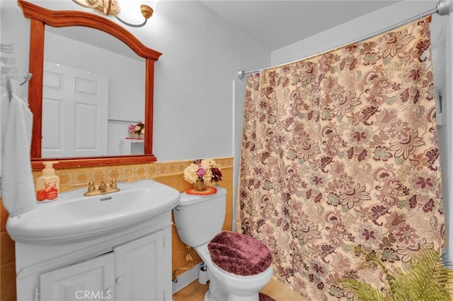 bathroom with walk in shower, vanity, and toilet