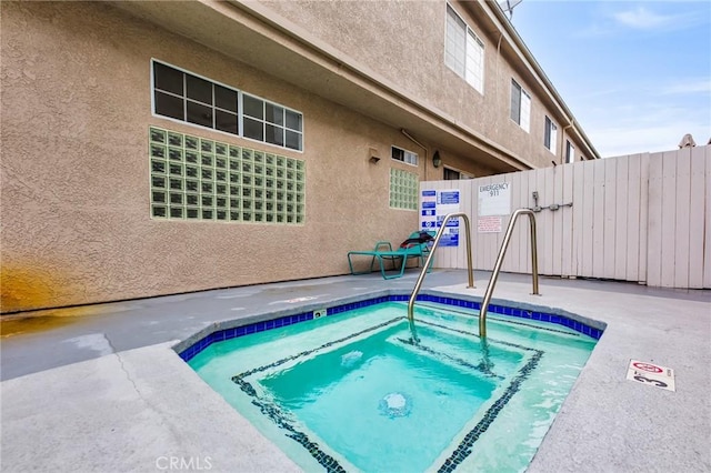 view of swimming pool with a hot tub and a patio area