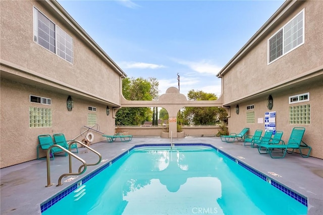 view of swimming pool with a patio area