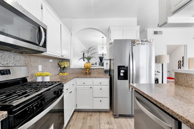 kitchen featuring visible vents, decorative backsplash, light wood-style flooring, appliances with stainless steel finishes, and white cabinetry