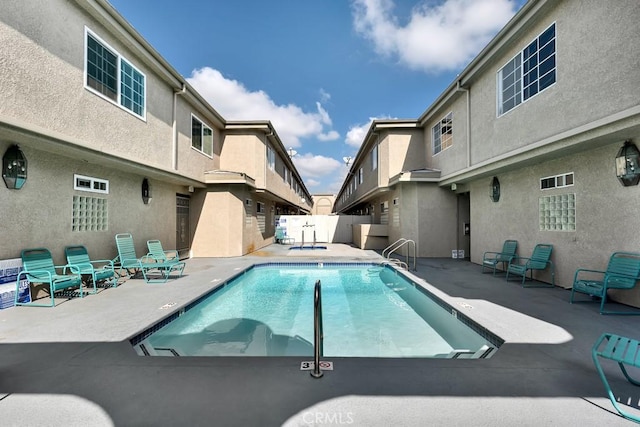 pool featuring a patio area and fence