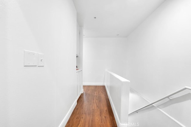 hallway with baseboards and wood finished floors