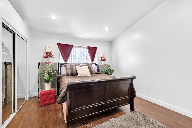 bedroom featuring recessed lighting, a closet, baseboards, and wood finished floors