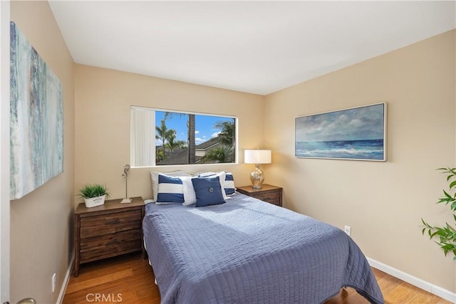 bedroom with hardwood / wood-style floors