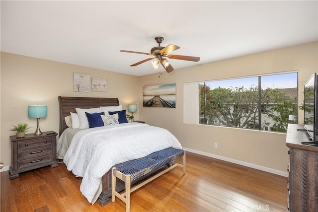 bedroom with ceiling fan and hardwood / wood-style floors