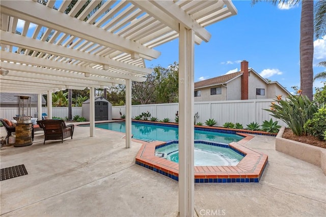 view of pool featuring a storage shed, a pergola, a patio, and an in ground hot tub