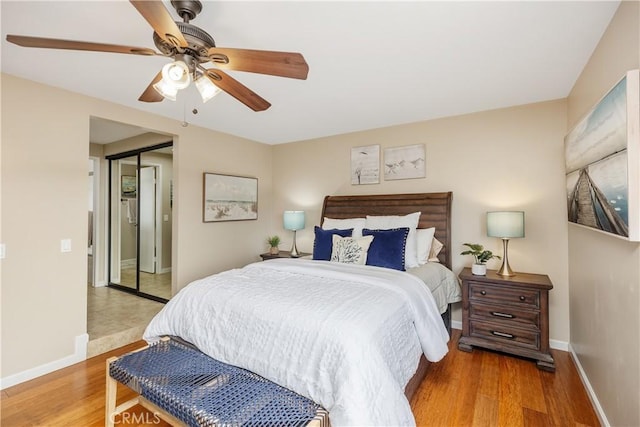 bedroom with ceiling fan, a closet, and wood-type flooring