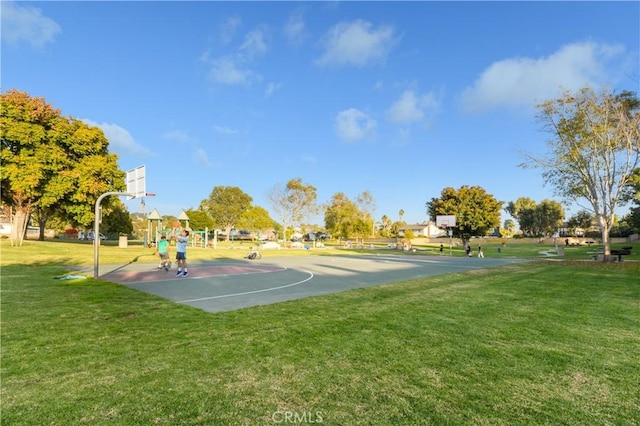 view of sport court featuring a lawn and a playground