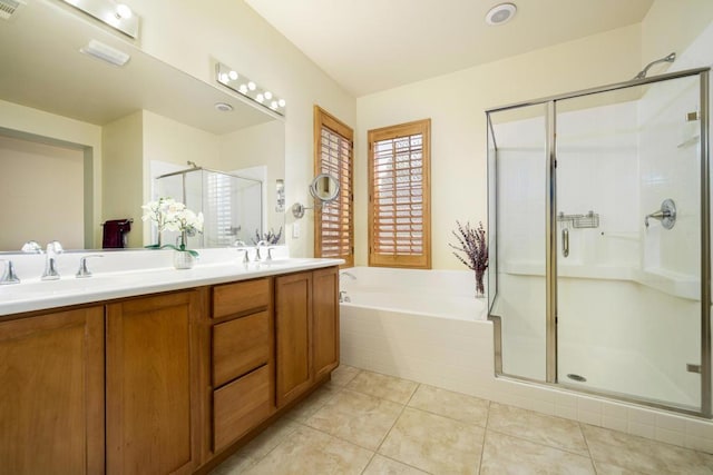 bathroom with tile patterned floors, vanity, and separate shower and tub