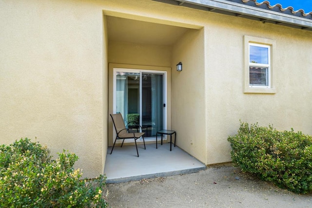 entrance to property with a patio area