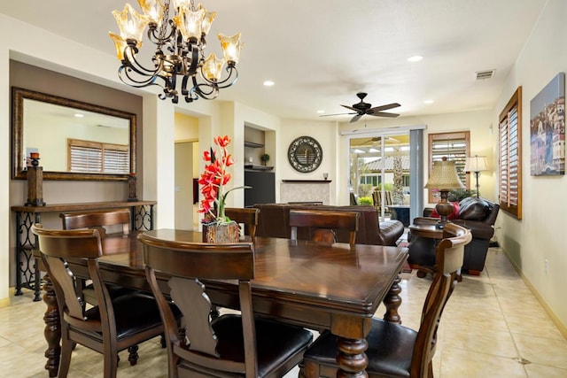 dining space featuring built in features and ceiling fan with notable chandelier