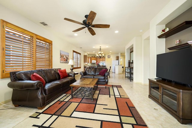 living room with ceiling fan with notable chandelier