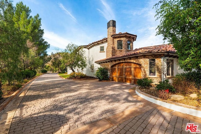 mediterranean / spanish-style house featuring a garage