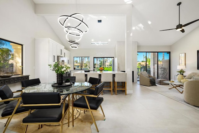 dining room featuring beamed ceiling, high vaulted ceiling, and ceiling fan with notable chandelier