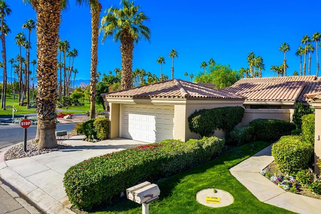 mediterranean / spanish house featuring a garage