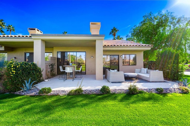 rear view of house with a patio, an outdoor hangout area, and a lawn