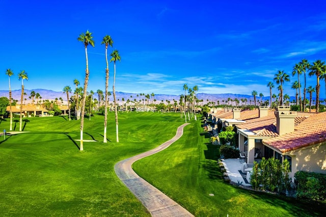 surrounding community featuring a mountain view and a yard