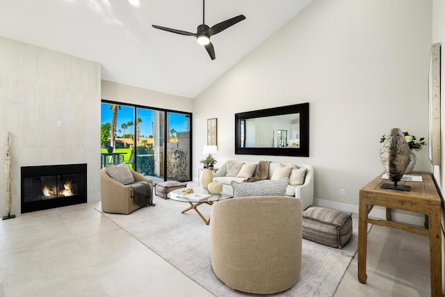 living room featuring a fireplace, high vaulted ceiling, and ceiling fan