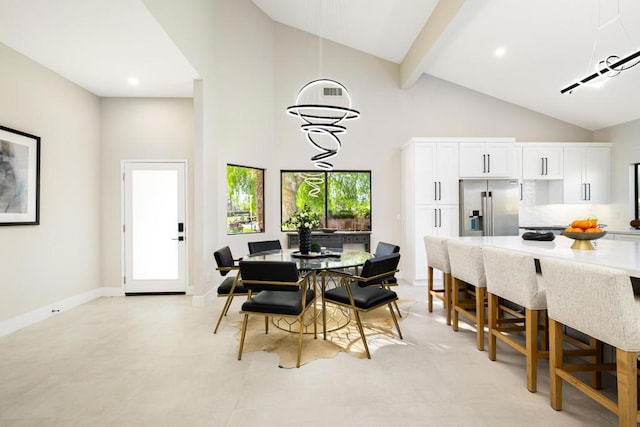 dining area featuring beamed ceiling and a high ceiling