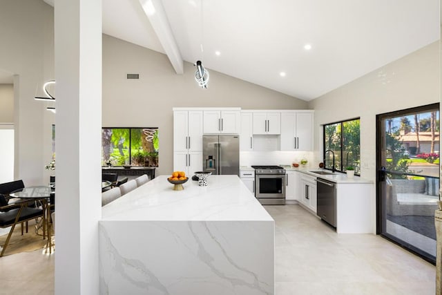 kitchen featuring sink, white cabinetry, stainless steel appliances, high vaulted ceiling, and light stone countertops