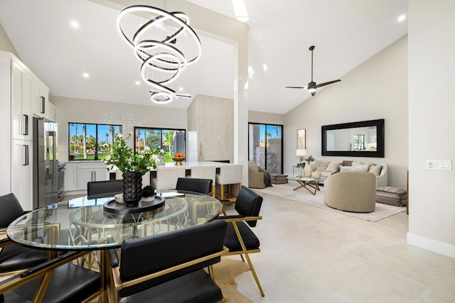 dining space featuring vaulted ceiling and ceiling fan with notable chandelier