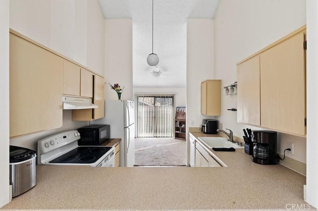 kitchen featuring ceiling fan, sink, white electric range oven, and a towering ceiling