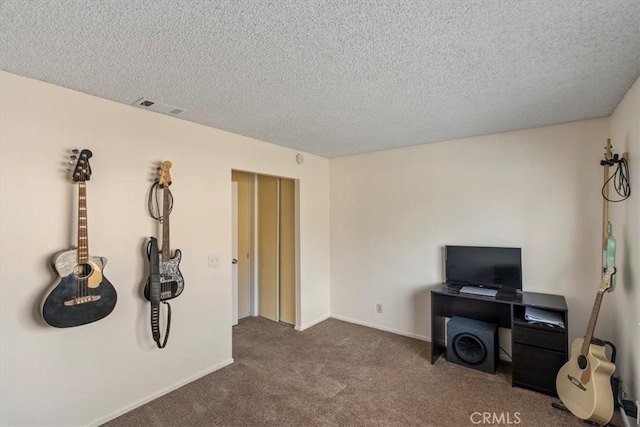 misc room with carpet and a textured ceiling