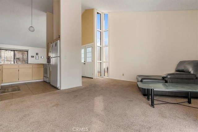 living area featuring a towering ceiling