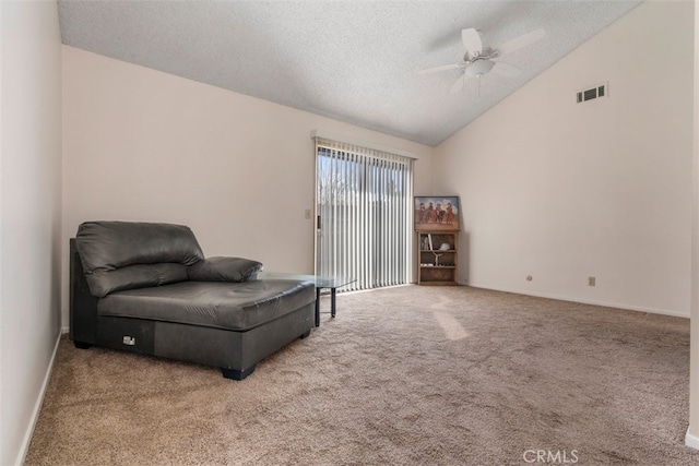 living area featuring a textured ceiling, ceiling fan, carpet flooring, and lofted ceiling