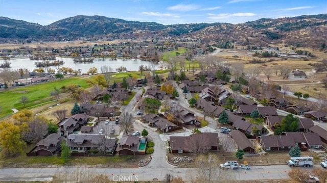 aerial view featuring a water and mountain view