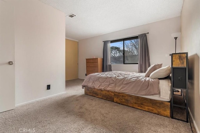 carpeted bedroom with a textured ceiling