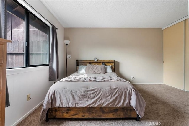 bedroom with carpet and a textured ceiling