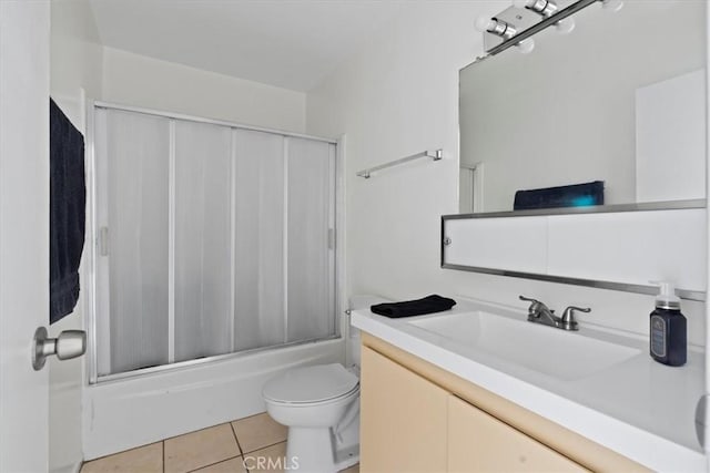 full bathroom with toilet, vanity, tile patterned floors, and shower / bath combination with glass door