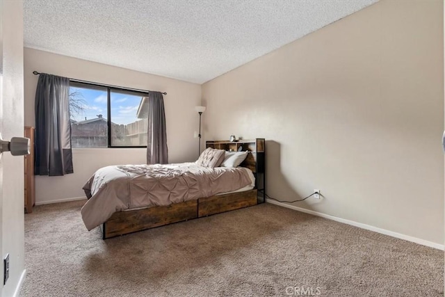 carpeted bedroom featuring a textured ceiling