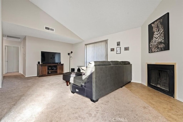 carpeted living room featuring lofted ceiling