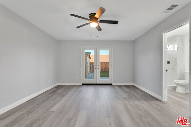 empty room with ceiling fan, french doors, and light hardwood / wood-style floors