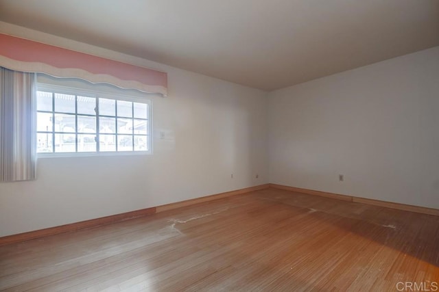 spare room with light hardwood / wood-style floors