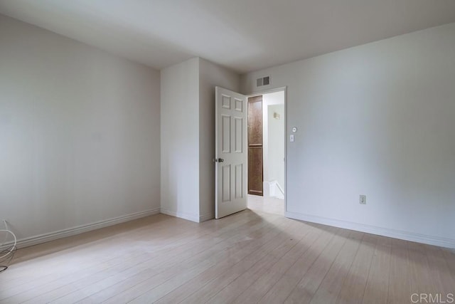 spare room with light hardwood / wood-style floors