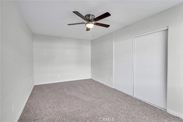 unfurnished bedroom featuring ceiling fan, a closet, and carpet floors