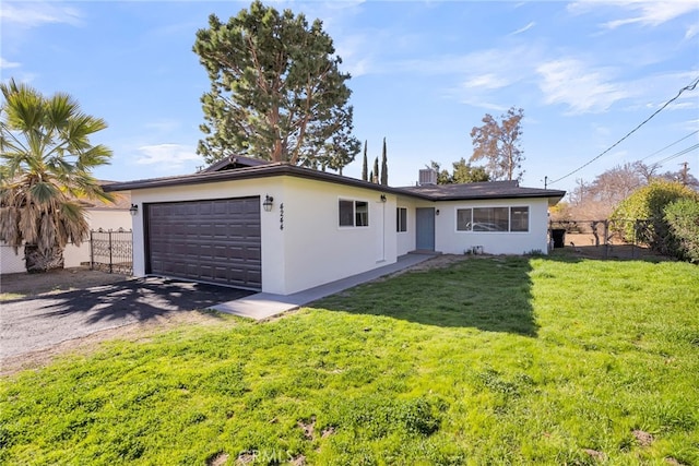 single story home featuring a garage, a front lawn, and central AC