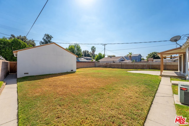 view of yard with central AC unit and a patio