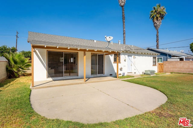 back of property featuring cooling unit, a yard, and a patio