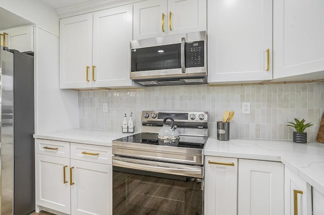 kitchen with white cabinets, appliances with stainless steel finishes, tasteful backsplash, hardwood / wood-style flooring, and light stone counters