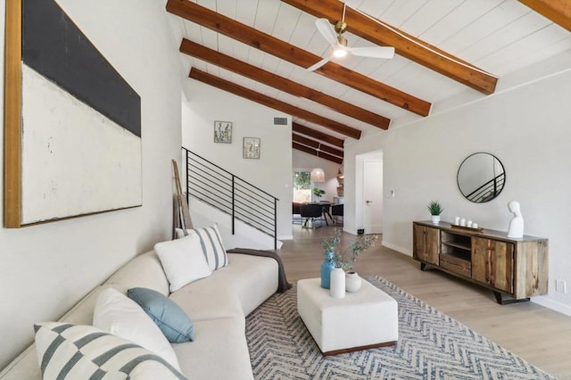 living room featuring light wood-type flooring, ceiling fan, high vaulted ceiling, and beamed ceiling