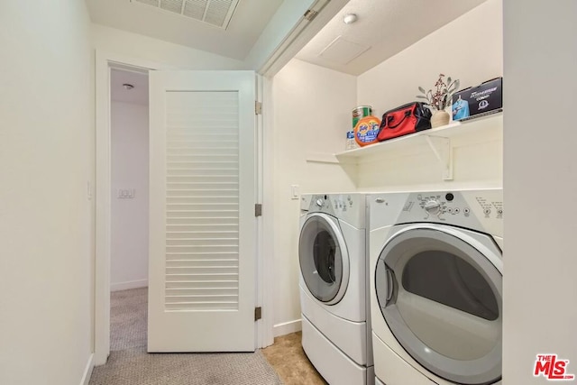 laundry area with light carpet and separate washer and dryer