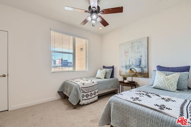 bedroom with ceiling fan and light carpet