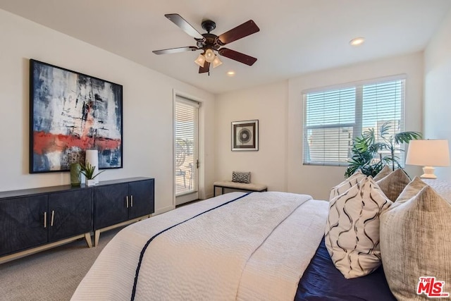 carpeted bedroom with ceiling fan, access to outside, and multiple windows