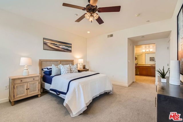 carpeted bedroom featuring ceiling fan and connected bathroom