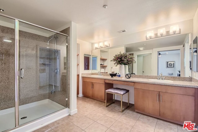 bathroom with ceiling fan, tile patterned flooring, an enclosed shower, and vanity