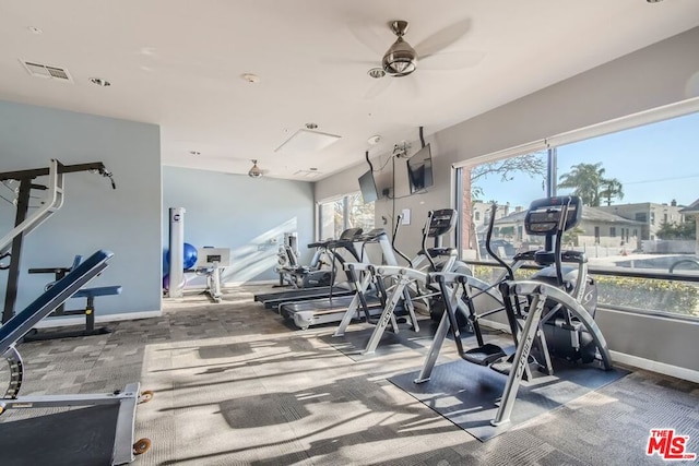 workout area featuring ceiling fan and a wealth of natural light